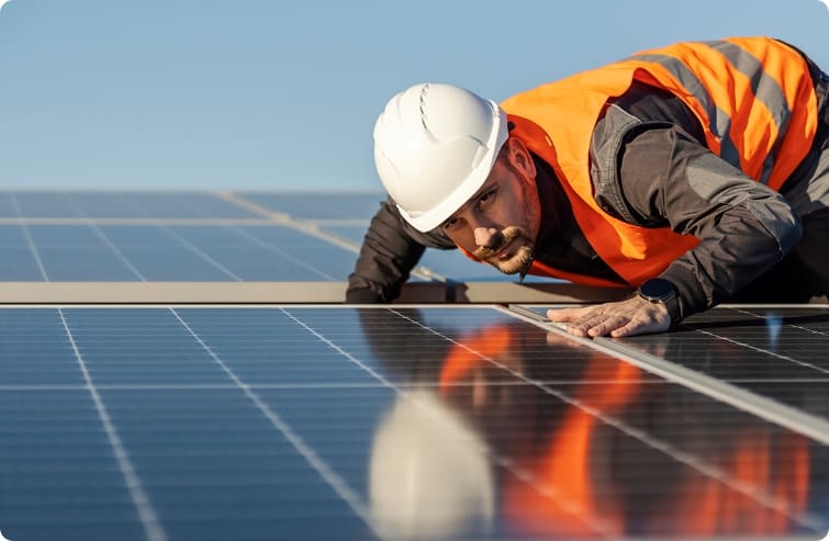 employee looking at solar panel
