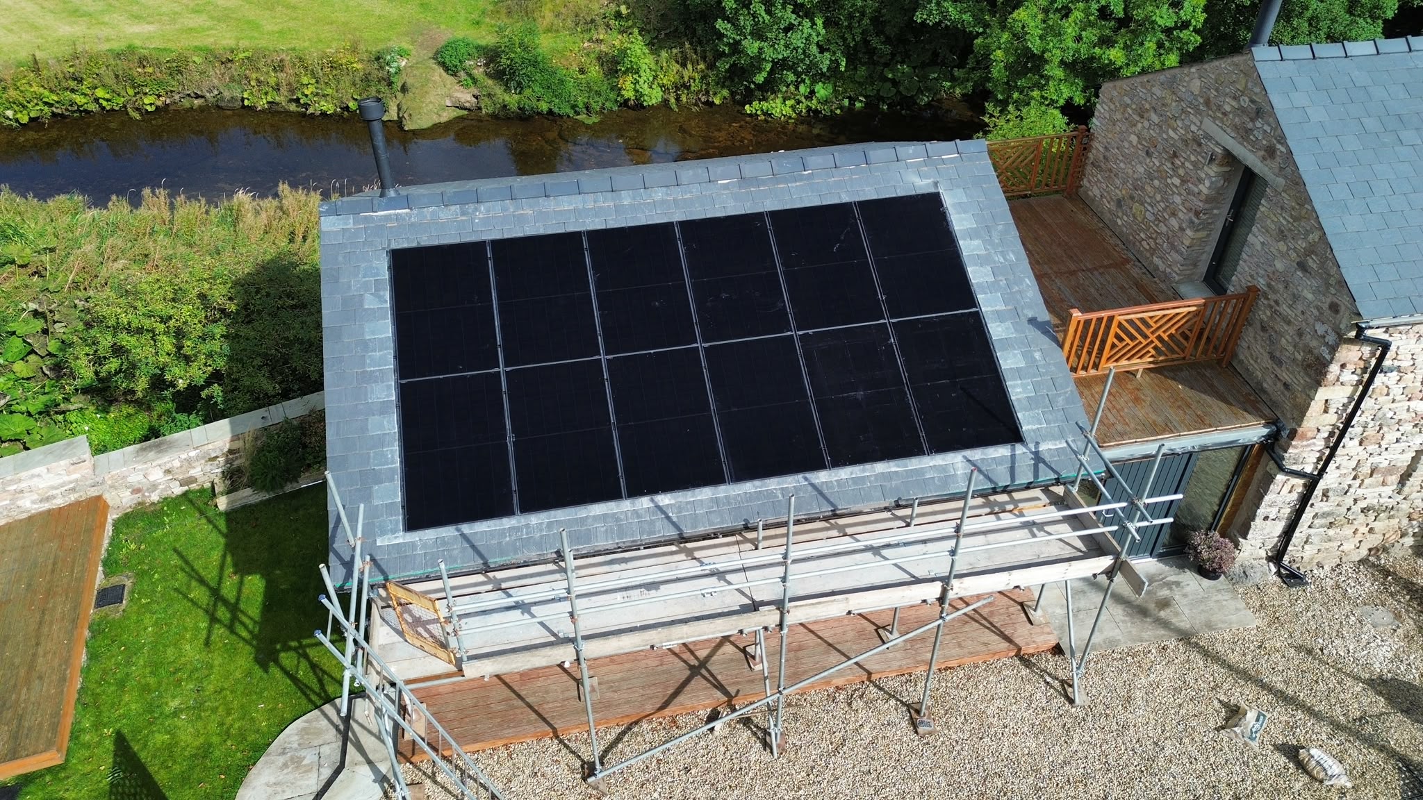 Close view of the twelve-panel in-roof solar array framed by slate tiles