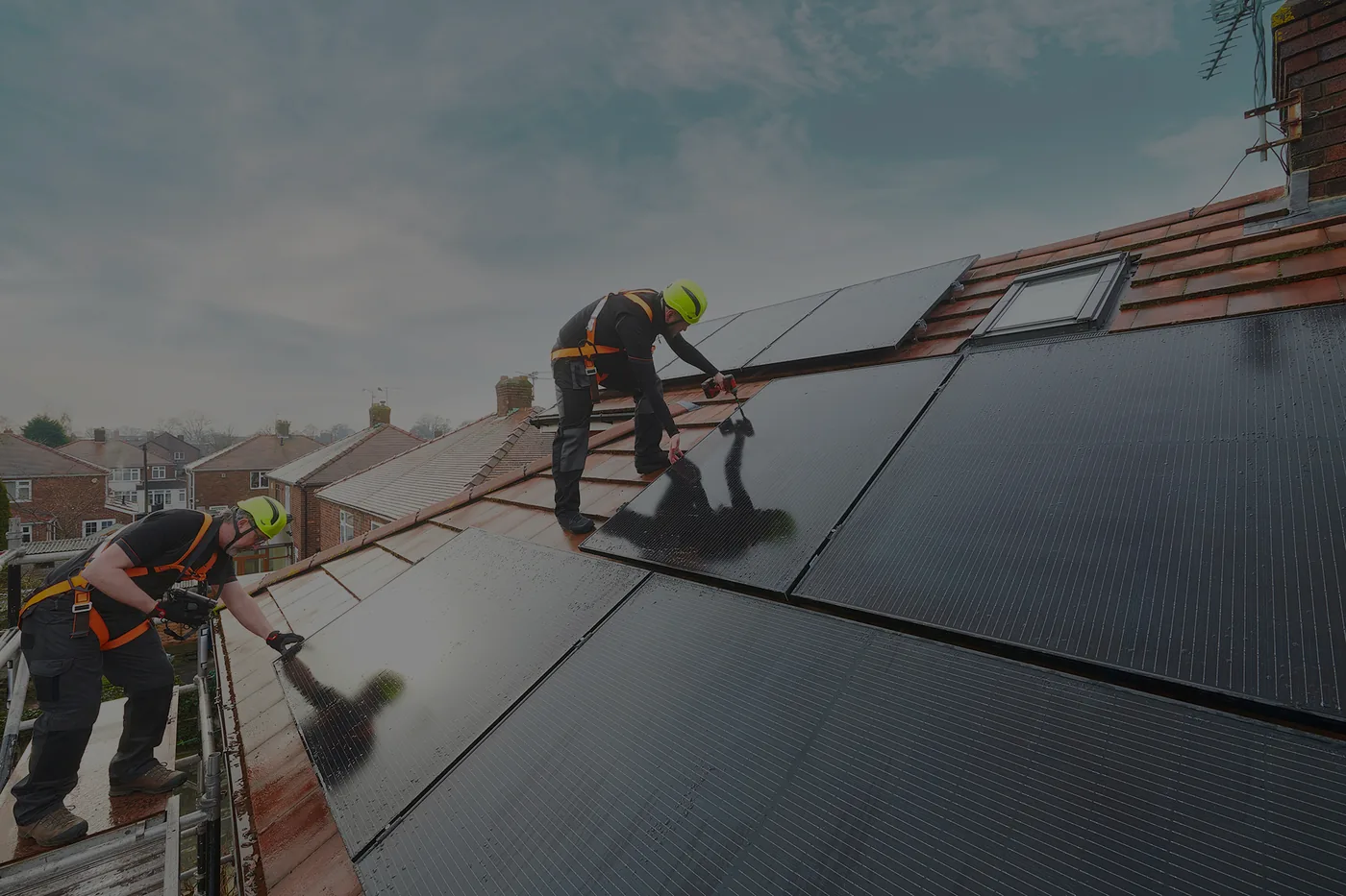 Solar panels being professionally installed on a tiled roof
